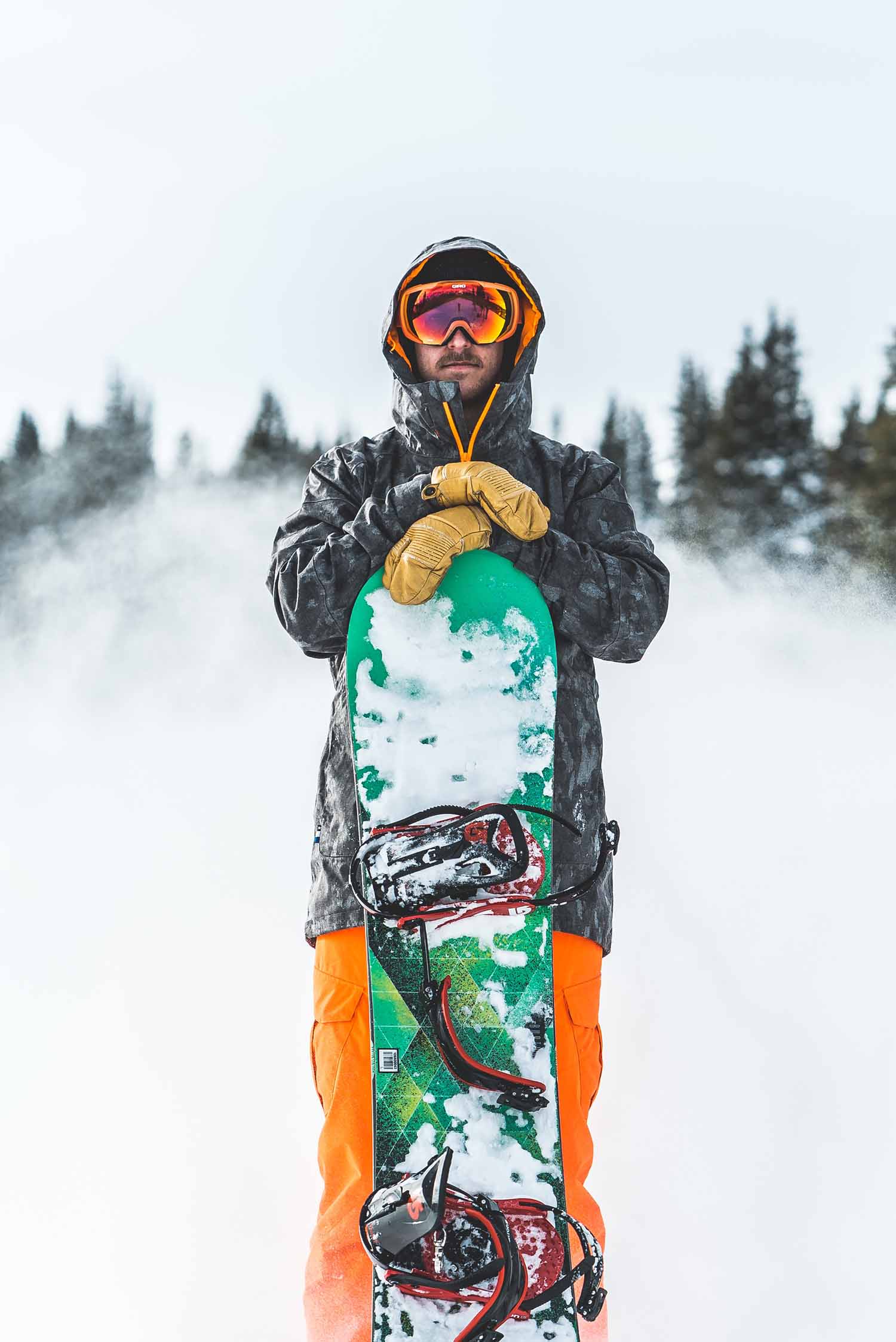 a person holding a yellow snowboard